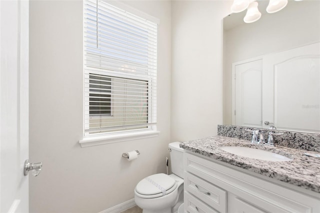 bathroom featuring toilet and vanity with extensive cabinet space