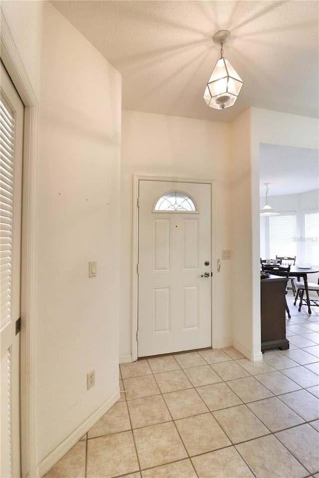 foyer entrance with light tile floors