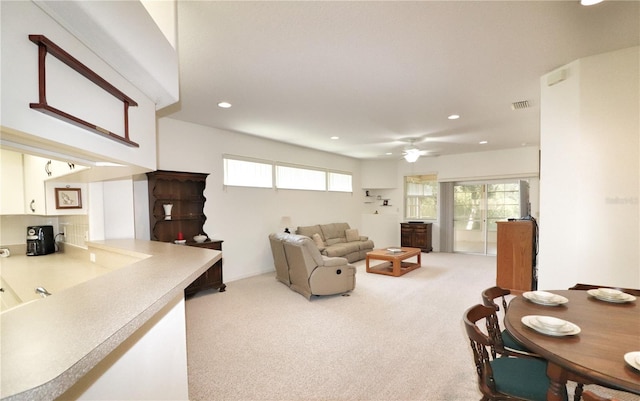 carpeted living room featuring ceiling fan