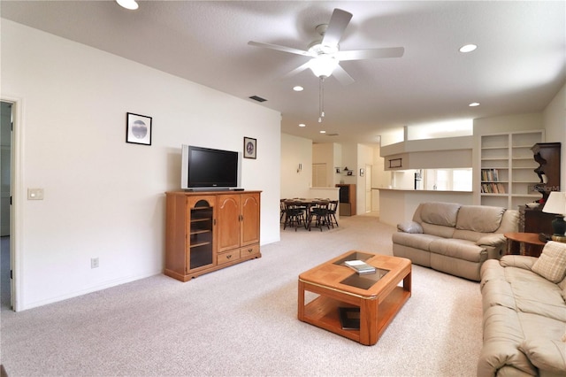 living room featuring light colored carpet and ceiling fan