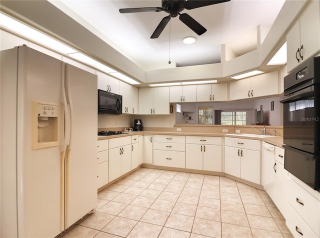 kitchen with light tile floors, ceiling fan, white cabinets, and black appliances