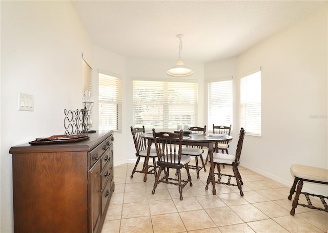 dining room with a healthy amount of sunlight and light tile floors