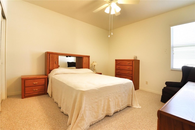 carpeted bedroom featuring ceiling fan and multiple windows