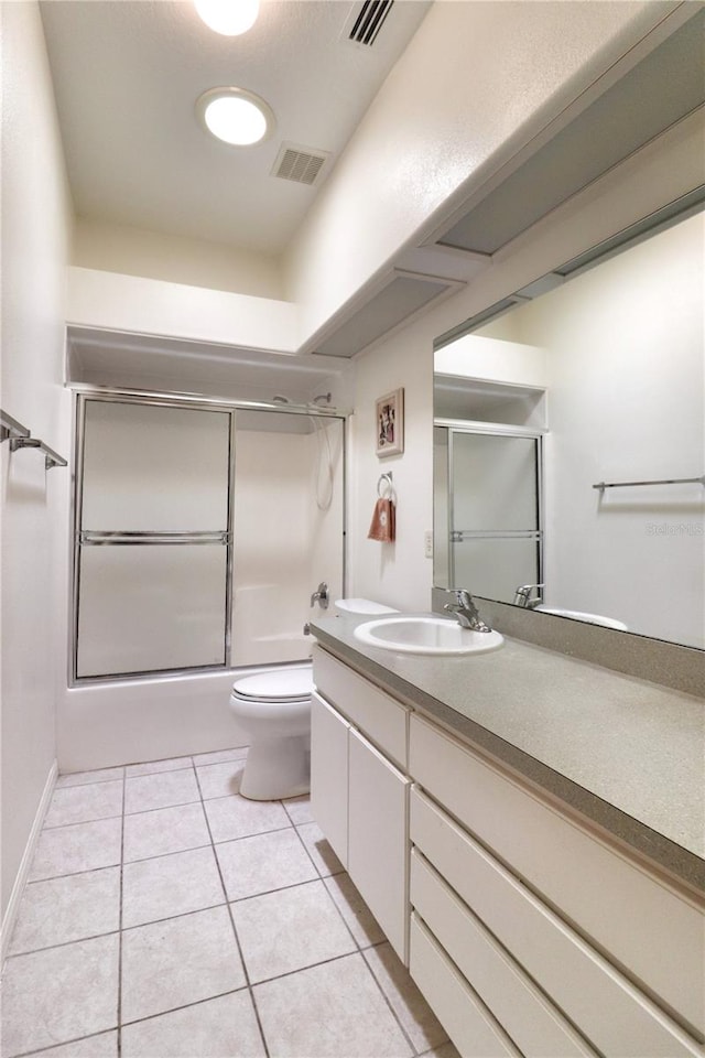 full bathroom with toilet, shower / bath combination with glass door, vanity, and tile flooring