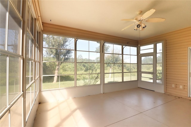 unfurnished sunroom featuring ceiling fan