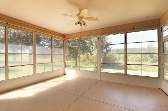 unfurnished sunroom featuring ceiling fan