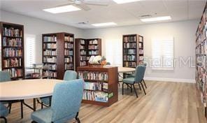 home office with ceiling fan and light hardwood / wood-style flooring