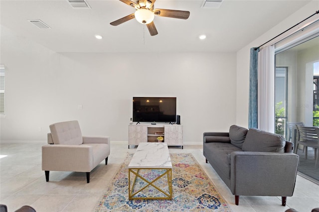 living room featuring light tile flooring and ceiling fan