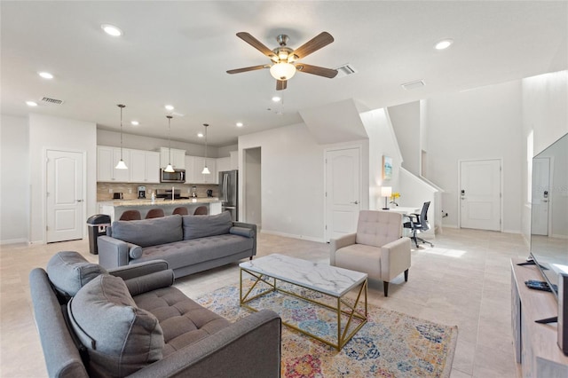 tiled living room with ceiling fan