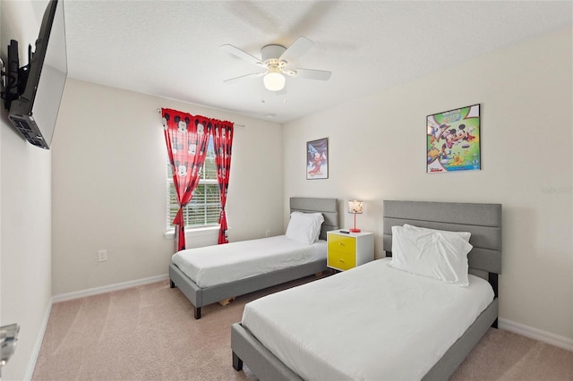 carpeted bedroom featuring ceiling fan and a textured ceiling