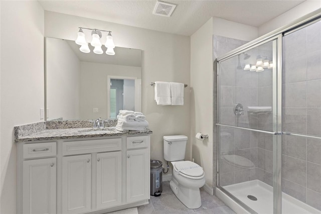 bathroom featuring toilet, oversized vanity, a textured ceiling, walk in shower, and tile flooring