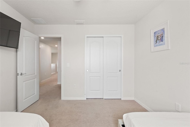 carpeted bedroom featuring a closet