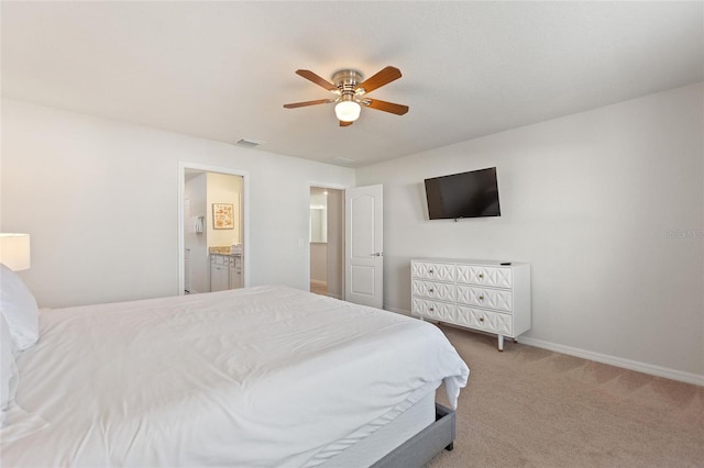 carpeted bedroom featuring ensuite bathroom and ceiling fan