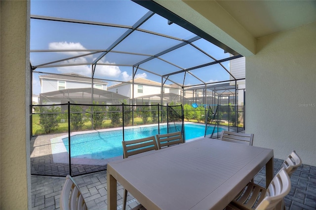 view of swimming pool featuring a patio area and glass enclosure