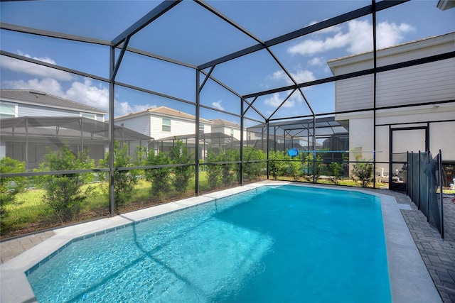 view of pool with glass enclosure