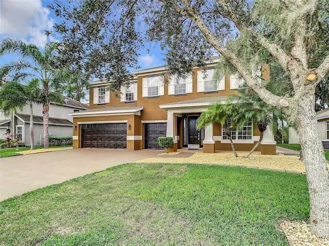 view of front of home featuring a front yard and a garage