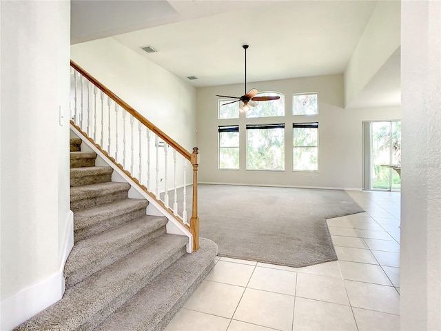 carpeted foyer featuring ceiling fan and plenty of natural light