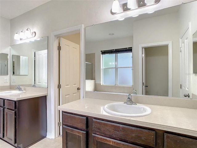 bathroom with vanity, tile patterned floors, and a shower with door