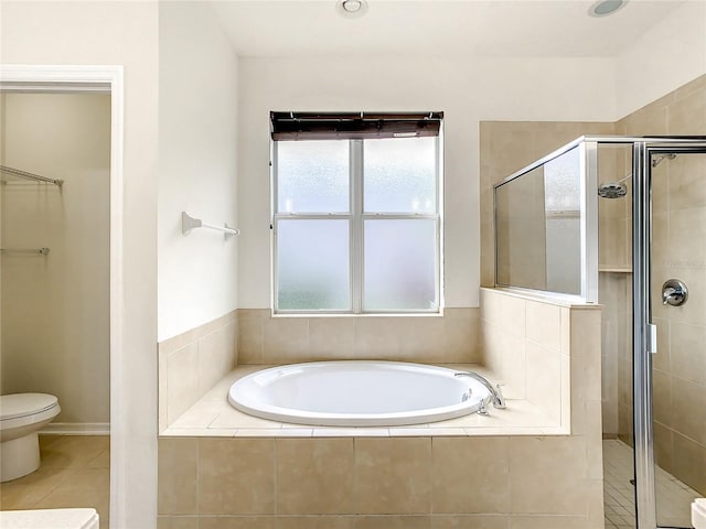 bathroom with tile patterned floors, toilet, and shower with separate bathtub