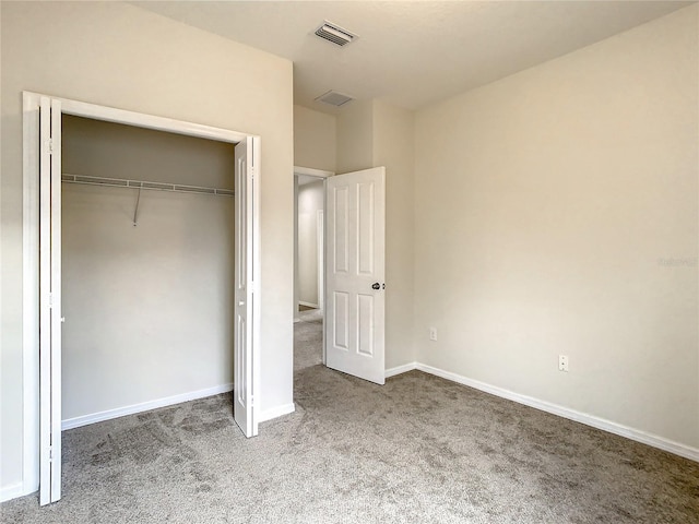 unfurnished bedroom with a closet and carpet floors