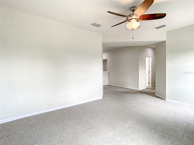 carpeted spare room with vaulted ceiling and ceiling fan