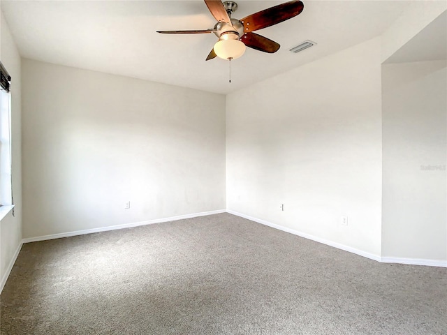 empty room with ceiling fan and carpet floors