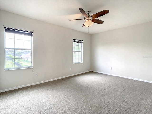 carpeted empty room featuring ceiling fan