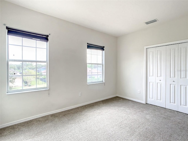 unfurnished bedroom featuring carpet and a closet