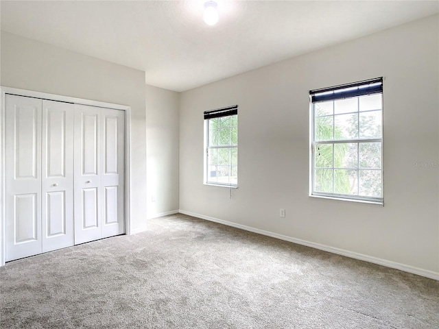 unfurnished bedroom featuring carpet and a closet