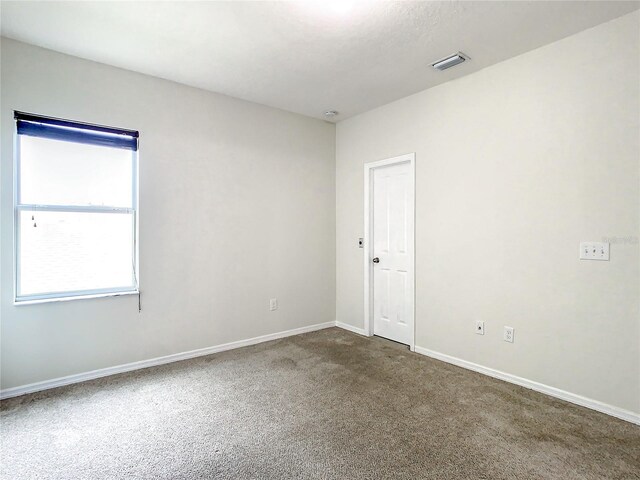 spare room featuring carpet floors