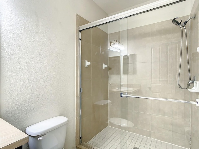 bathroom with vanity, toilet, and an enclosed shower