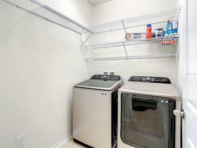 clothes washing area with washing machine and dryer