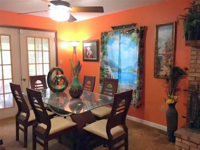 dining area featuring carpet, ceiling fan, and french doors