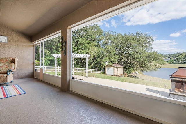 10120 Lakeshore Dr, Clermont, FL 34711 - unfurnished sunroom featuring a water view, lofted ceiling, and view of wooded area