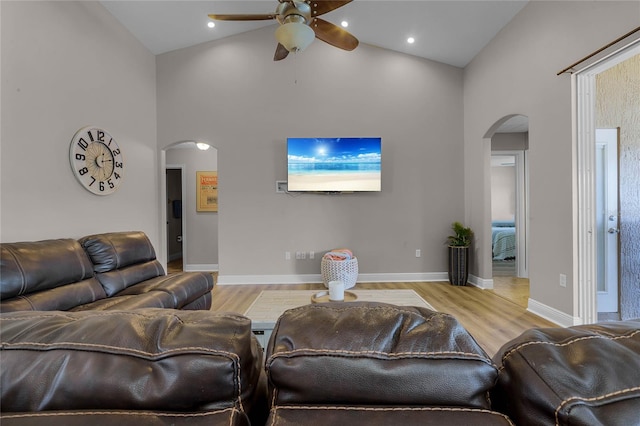 10120 Lakeshore Dr, Clermont, FL 34711 - living area featuring arched walkways, a ceiling fan, wood finished floors, and high vaulted ceiling