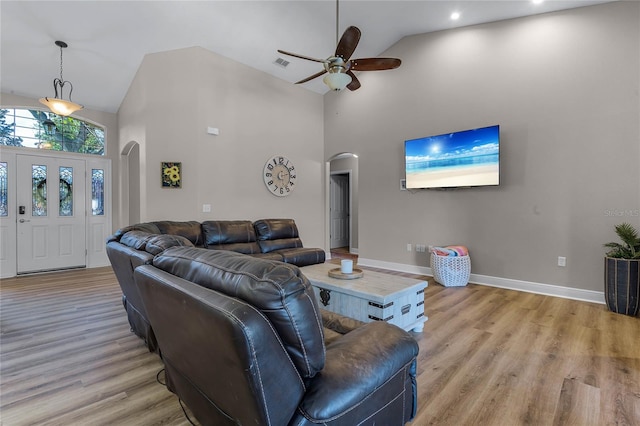 10120 Lakeshore Dr, Clermont, FL 34711 - living area with arched walkways, high vaulted ceiling, ceiling fan, and light wood-style flooring