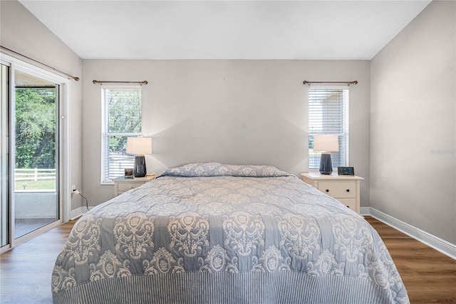 10120 Lakeshore Dr, Clermont, FL 34711 - bedroom with access to exterior and wood finished floors