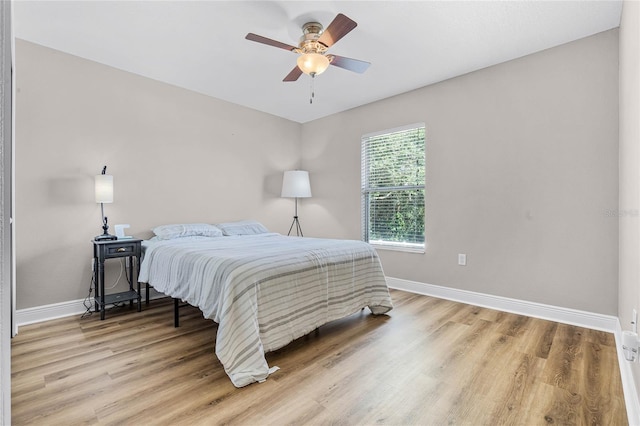 10120 Lakeshore Dr, Clermont, FL 34711 - bedroom with light wood finished floors and ceiling fan