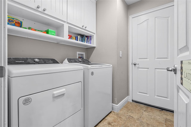 10120 Lakeshore Dr, Clermont, FL 34711 - laundry room featuring cabinet space, washing machine and clothes dryer, and light stone finish floors
