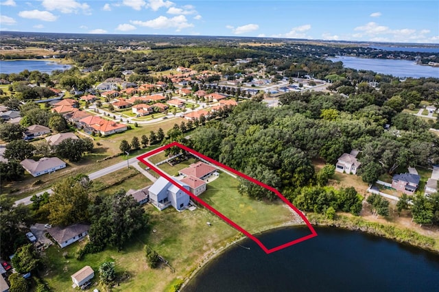 10120 Lakeshore Dr, Clermont, FL 34711 - aerial perspective of suburban area featuring property parcel outlined and a large body of water