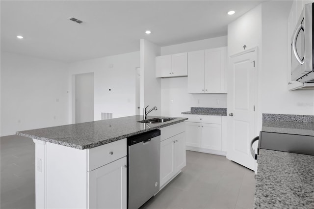 kitchen featuring an island with sink, white cabinets, sink, and appliances with stainless steel finishes