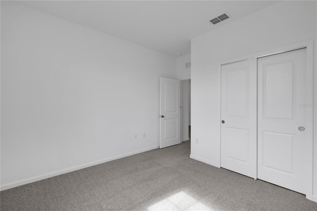 unfurnished bedroom featuring carpet floors and a closet