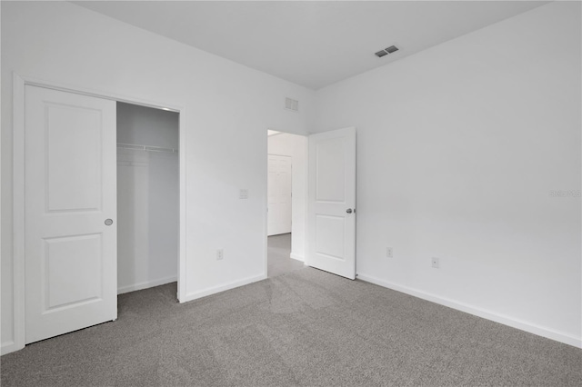 unfurnished bedroom with a closet and carpet flooring