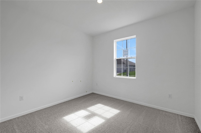 unfurnished room with light carpet