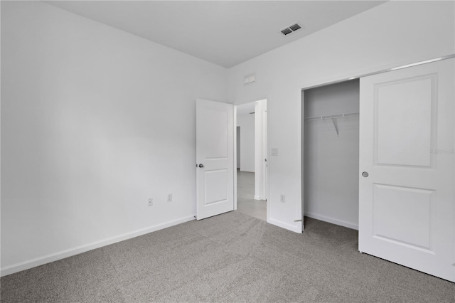 unfurnished bedroom with carpet and a closet