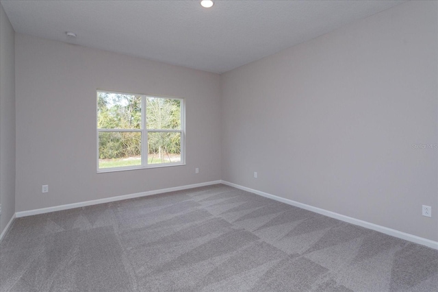 spare room featuring light colored carpet