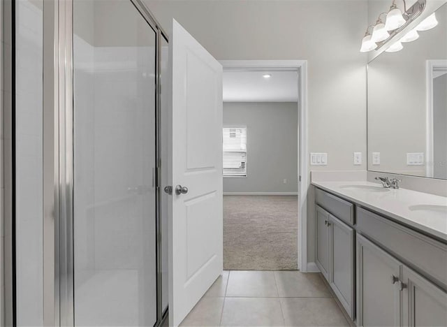 bathroom featuring double vanity, tile flooring, and a shower with door