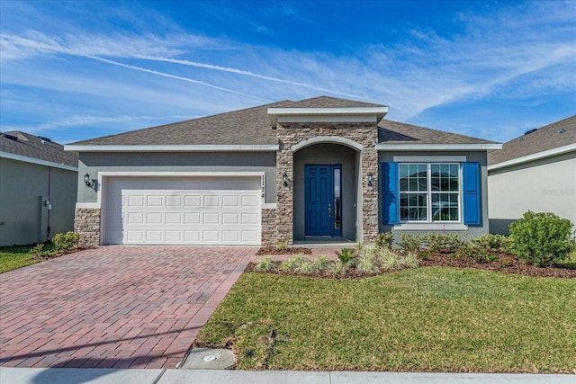 view of front of house with a front yard and a garage