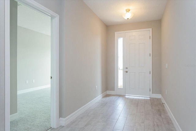 view of carpeted foyer