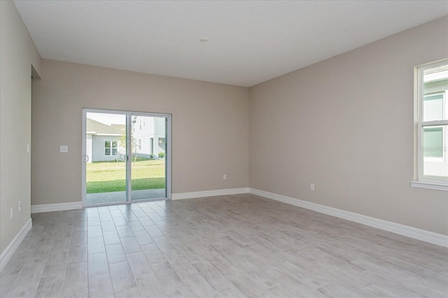 empty room with light hardwood / wood-style floors